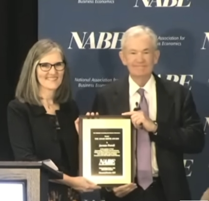 Emily Kolinski Morris presents Jerome Powell with the Adam Smith Award